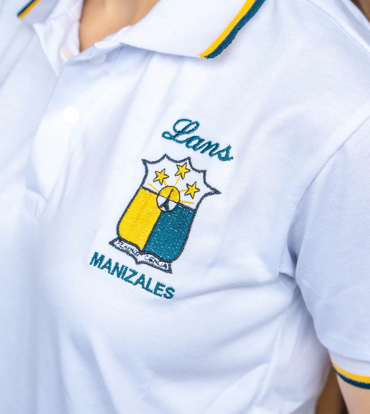 Escudo bordado del colegio Lans en polo blanco con ribete